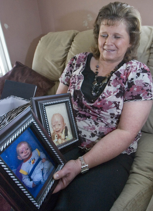 Paul Fraughton | The Salt Lake Tribune.
Halena Black shows photos of her sons Hyrum ,left, born in 1987 and Kenny Rae, born in 1979. Both boys died in infancy from what is now being termed Ogden Syndrome.
 Tuesday, February 14, 2012