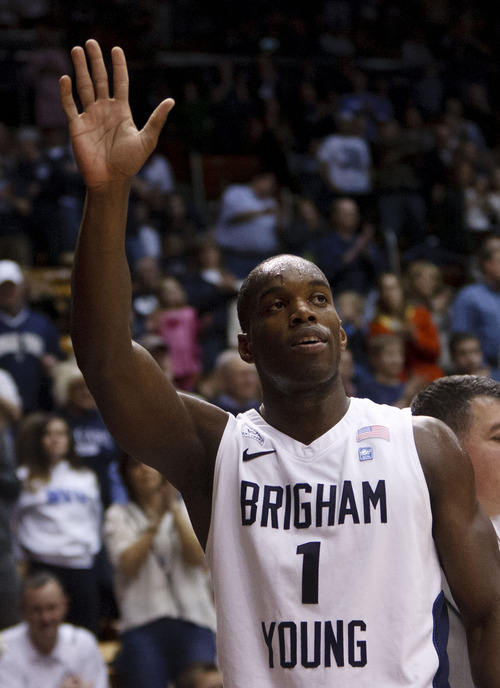 Trent Nelson  |  The Salt Lake Tribune
Senior BYU guard/forward Charles Abouo (1) acknowledges the crowd after leaving the game, his final regular season home game for BYU. BYU vs. Portland, college basketball Saturday, February 25, 2012 in Provo, Utah.
