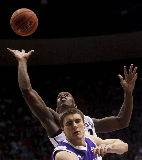 Trent Nelson  |  The Salt Lake Tribune
BYU guard/forward Charles Abouo (1) shoots over Portland guard Tanner Riley (3). BYU vs. Portland, college basketball Saturday, February 25, 2012 in Provo, Utah.