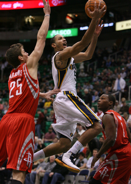 Steve Griffin  |  The Salt Lake Tribune

Utah Jazz guard Devin Harris gets past Houston's Chandler Parsons as he lays in two points during first half action in the Jazz Rockets game at EnergySolutions Arena in Salt Lake City, Utah  Wednesday, February 29, 2012.