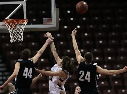 Kim Raff  |  The Salt Lake Tribune
Viewmont player (middle) Travis Tiner and Riverton players (left) Richard Worsham and Stephen Holm battle for a rebound during the 5A UHSAA State Tournament at the Maverick Center in Salt Lake City, Utah on February 28, 2012.  Riverton went on to win the game 52-21 in double overtime.