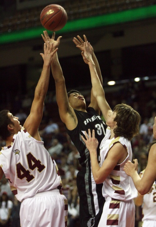 Kim Raff  |  The Salt Lake Tribune
Viewmont players (left) Haden Heath and Travis Tiner defend as Riverton player Tevita Loamanu takes a shot during the 5A UHSAA State Tournament at the Maverick Center in Salt Lake City, Utah on February 28, 2012.  Riverton went on to win the game 52-21 in double overtime.