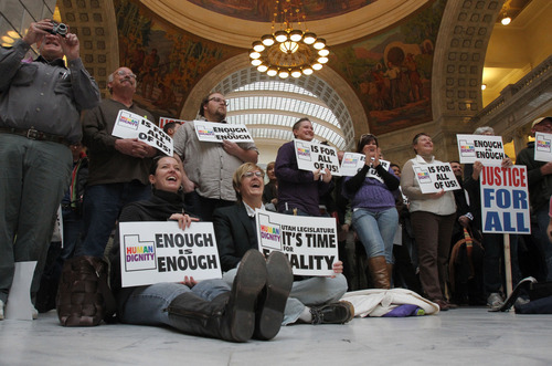 Francisco Kjolseth  |  The Salt Lake Tribune
Supporters of Utah's lesbian, gay, bisexual and transgender community hold signs at the Human Dignity Rally on Wednesday at the Utah State Capitol. They protested a decision by a Senate committee to table an anti-discrimination law earlier this month.