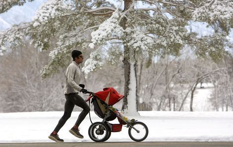 Al Hartmann  |  The Salt Lake Tribune
A runner with a baby stroller runs through Sugar House Park Thursday morning after Wednesday night's snowstorm. Another storm is on the way.