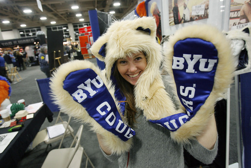 Francisco Kjolseth  |  The Salt Lake Tribune
Anne Nadel with Spirit Hoods based in L.A. CA, shows off one of the schools featured in their furry head and hand covers. The Campus Market Expo currently fills the Calvin L. Rampton Salt Palace Convention Center featuring 719 exhibitors in 1,491 booths showing off the latest tech stuff, celebration wears and sports gear being sold at college campus book stores around the country.