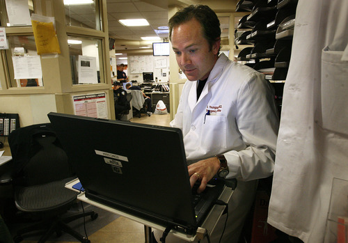 Scott Sommerdorf  |  The Salt Lake Tribune             
Scott Youngquist, an attending physician in the University of Utah's emergency department checks the roster of incoming patients. He is seeing more people for untreated dental problems.