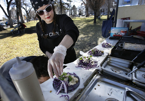Scott Sommerdorf  |  The Salt Lake Tribune             
Larayne Clegg puts the garnish on some vegan tacos at her Union Street Eats, a vegan food cart, across the street from the Main Library, Sunday, March 4, 2012.