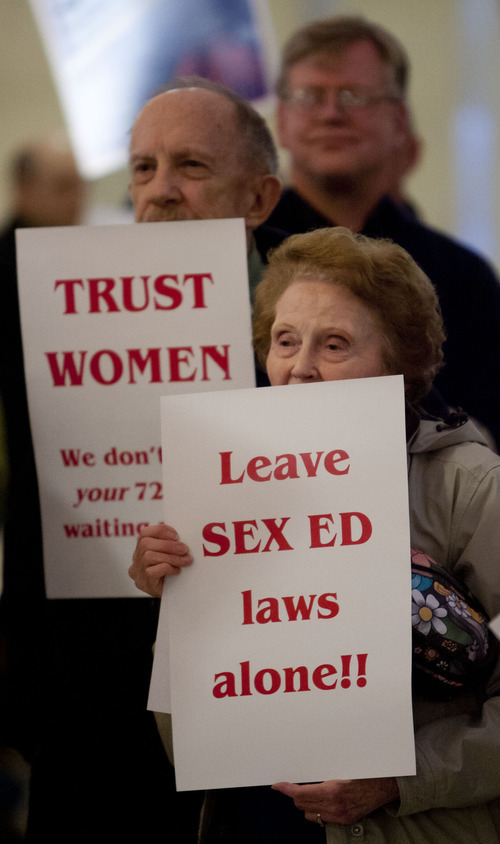 Trent Nelson  |  The Salt Lake Tribune
Stuart Gygi, left, and Joyce Barnes hold up signs protesting the Legislature's action in removing a requirement for sex education in schools and moving toward imposing a 72-hour waiting period for women seeking abortions. The two were part of a 