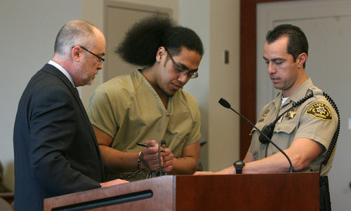 Steve Griffin  |  The Salt Lake Tribune

Attorney  Richard Van Wagoner, stands with his client, Hunter Farani, as he signs paperwork after pleading guilty to two counts of aggravated kidnapping and one count of aggravated murder for the murder of 18-year-old JoJo Lee Brandstatt in 2009, during a change of plea hearing at the Matheson Courthouse in Salt Lake City, Utah  Thursday, March 8, 2012.  Farani was barely 14 when he shot Brandstatt for wearing the color of a rival gang.