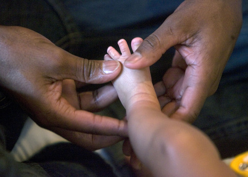 Al Hartmann  |  The Salt Lake Tribune
Abdulkhalia Mohamed massages the feet and legs of his 5-week-old son Ismail at a class at the Vitalize Community Studio in Salt Lake City.