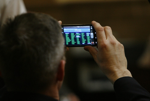 Scott Sommerdorf  |  The Salt Lake Tribune             
Rep. Tim Cosgrove, D-Murray, takes a photo of his bill passing through the Utah House of Representatives Thursday. His bill, HB162 - Veterans Reintigration Task Force, passed easily on the final day of the session.
