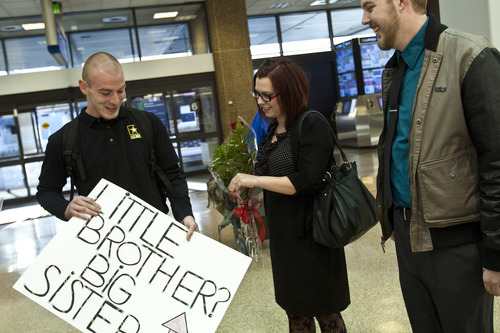 Chris Detrick  |  The Salt Lake Tribune
Stephanie Cook and her brother Thomas Linton talk after meeting for the first time at the Salt Lake City International Airport Thursday. Her husband, Trevin Cook, as at right. Stephanie Cook was 1 when her mother, Bobbi Ann Campbell, gave birth to a boy. Days later, Bobbi placed the boy for adoption. Four years later, Bobbi disappeared and police have yet to resolve what happened to her. Stephanie, 22, was raised by her great-grandparents, while her brother grew up in Mapleton. When she was a teenager, she came across infant photos of her brother, whom she knew was named Thomas. She always thought he grew up in Seattle. But in January she randomly googled 