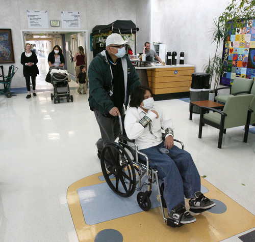 Steve Griffin  |  The Salt Lake Tribune

Ethan Skacy, 13, is wheeled into an auditorium at Primary Children's Medical Center, by his father Francis Skacy, for a press conference about Ethan's heart and liver transplant in Salt Lake City, Utah  Friday, March 9, 2012. The family is from Tuba City, AZ.