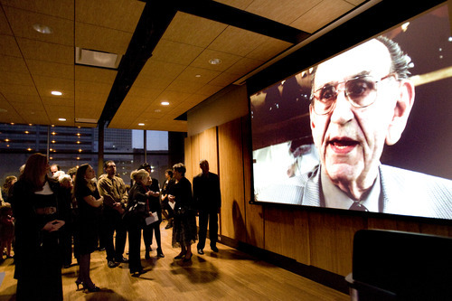 Kim Raff | The Salt Lake Tribune 
People gather to watch a video of Richard Wirick during a memorial service for him at Gallivan Hall at Gallivan Plaza in Salt Lake City on March 8, 2012.
