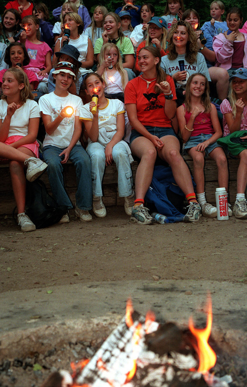 Tribune file photo

Girl Scouts gathered and singing with thier flashlights around a campfire at Trefoil Ranch in June 2001.