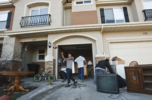 Leah Hogsten  |  The Salt Lake Tribune

KaPaw Htoo tosses a football to his younger brother as the family moves into a town home in Heber City in December. His family of seven shares the three-bedroom town home with a young, Karen couple to save money on rent.