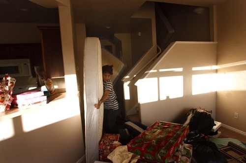 Leah Hogsten  |  The Salt Lake Tribune

In December, KaPaw Htoo moves his mattress into the living room, which doubles as his bedroom, in the family's new town home in Heber City. Initially, the family shared a smaller apartment with another refugee family as they waited for the town home to become available.