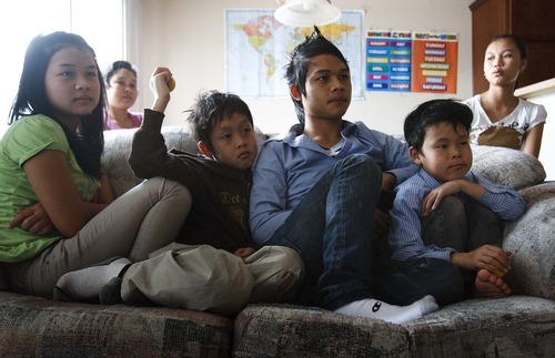 Leah Hogsten  |  The Salt Lake Tribune
Siblings Hae Thaw Paw, 12, Htoo Ka Paw Soe, 9, KaPaw Htoo, 16, and Htoo Ka Pru Soe, 8, from left, watch TV in their Heber City home as their mom, Paw Lae, left, chats with a friend in the background.