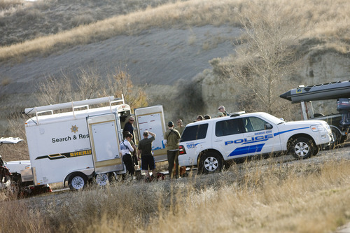 Kim Raff | The Salt Lake Tribune 
Police investigate a body found in the Jordan River off of the Jordan River Parkway on 12300 south in Draper, Utah on March 11, 2012.