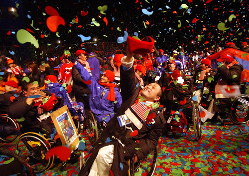 Rick Egan | Tribune file photo
Kanaichi Naiato, an althlete from Japan attempts to catch confetti in his hat as he celebrates at the end of the 2002 Paralympics closing ceremonies March 16, 2002.