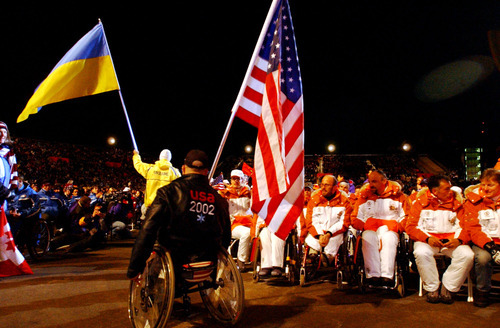Danny La | Tribune file photo
Flags of the participating countries including the Ukraine (background) and USA  flag (forground) are paraded during the Paralympics Closing Ceremony at the Medals Plaza in Salt Lake City on March 16, 2002.