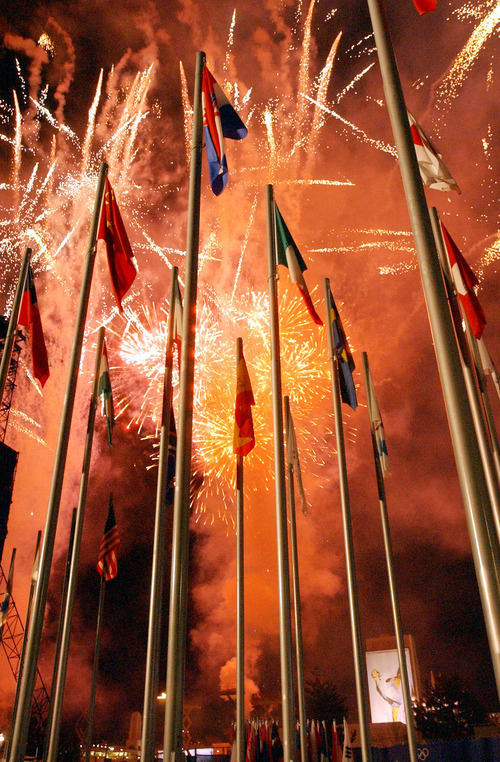 Danny La | Tribune file photo
Flags of multiple countries  with fireworks in the background at the 2002 Paralympic Closing Ceremony at the Medals Plaza in Salt Lake City on March 16, 2002.