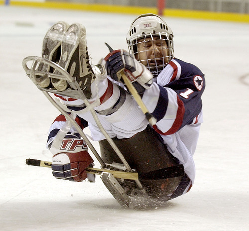 Steve Griffin | Tribune file photo
USA's Lonnie Hannah shoots a shot under his sled during the shootout of the gold medal game against Norway at the 2002 Paralympics. Hannah's shot missed.