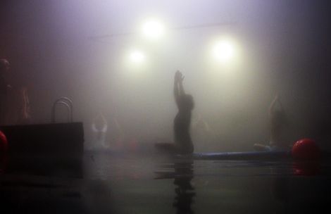 Steve Griffin  |  The Salt Lake Tribune

With steam filling the air Joanne Kellner, center, reaches up while sitting on a paddle board in Julia Geisler's yoga class at the Homestead Crater.