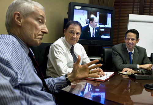 Scott Sommerdorf  |  The Salt Lake Tribune             
With a video feed from the Utah Senate showing Senator Daniel Thatcher, R-West Valley, speaking in the background, Utah Governor Gry Herbert, (center), listens as Lt Gov, Greg Bell, (left), speaks during a meeting of the Governor's staff in the Governor's board room, Thursday night, March 8, 2012. They were going over what bills were still in play in the Senate and House, and reviewing the finished work of the legislature as the session drew to a close.