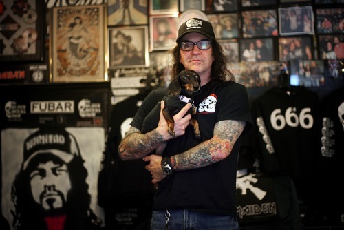 Kim Raff | The Salt Lake Tribune 
Kevin Kirk, owner of Heavy Metal Shop, that  is celebrating its 25th anniversary this year in the shop with his dog Sydney in Salt Lake City, Utah on March 14, 2012.