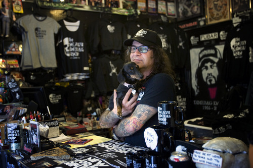 Kim Raff | The Salt Lake Tribune 
Kevin Kirk, owner of Heavy Metal Shop, that  is celebrating its 25th anniversary this year in the shop with his dog Sydney in Salt Lake City, Utah on March 14, 2012.