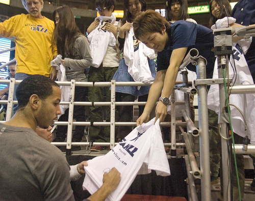 Paul Fraughton | The Salt Lake Tribune.
Utah's Devin Harris signs an autograph for a  fan visiting from Japan.
 Thursday, March 15, 2012