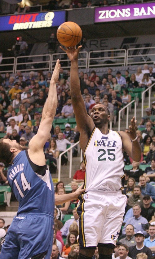 Paul Fraughton | The Salt Lake Tribune.
Utah's Al Jefferson  takes the shot over the outstretched arm of Minnesota's Nikola Pekovic. The Utah Jazz played the Minnesota Timberwolves at Energy Solutions Arena.
 Thursday, March 15, 2012