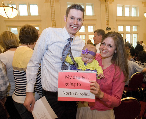 Paul Fraughton | The Salt Lake Tribune.
Kevin Dahle holds his match letter, as his wife  Natalie and daughter Kate, 6 months, hold a sign announcing Kevin's destination for his residency, the University of North Carolina. Match Day, where graduating medical students find out where they will do their residencies,  took place at Gardner Hall on the University of Utah campus on
Friday, March 16, 2012.
