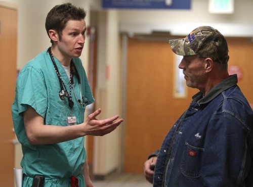 Rick Egan  | The Salt Lake Tribune 
U. student Kevin Dahle consults with Rex Hardy, at the Intermountain Medical Center on Friday, March 2, 2012. The graduating medical student started school before federal health reform and will be among the first to start a career under its rules.