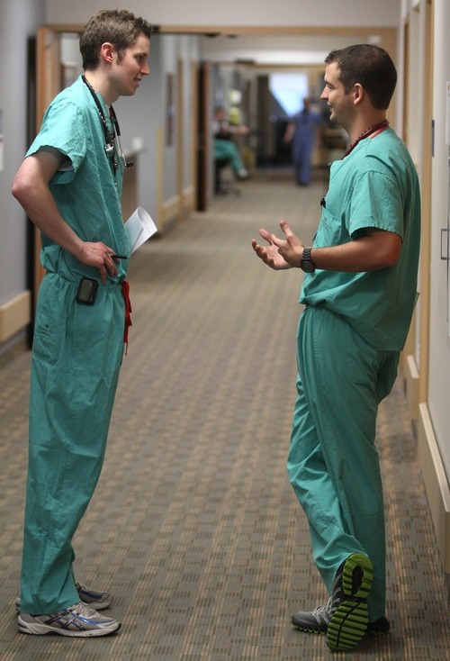 Rick Egan  | The Salt Lake Tribune 
Kevin Dahle chats with a fellow U. medical student, Wiley Thuet, on rounds at Intermountain Medical Center. Dahle started medical school before federal health reform and will be among the first to start a career under the law's rules.