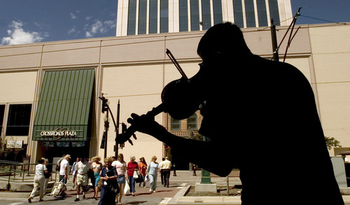 Al Hartmann  |  Tribune file photo
Street musician Chris Jacoby plays his violin to the noon crowds walking between Crossroads and ZCMI Malls on Main Street in Salt Lake i 2004.