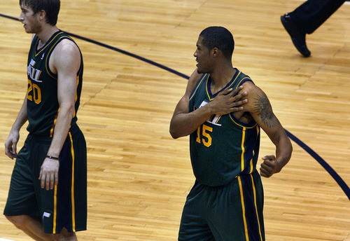 Scott Sommerdorf  |  The Salt Lake Tribune             
Utah center Derrick Favors held his left shoulder after a play where Golden State's Brandon Rush came down hard on his left shoulder during first half play. The Utah Jazz trailed the Golden State Warriors 51-46 at the half at Energy Solutions Arena, Saturday, March 17, 2012.