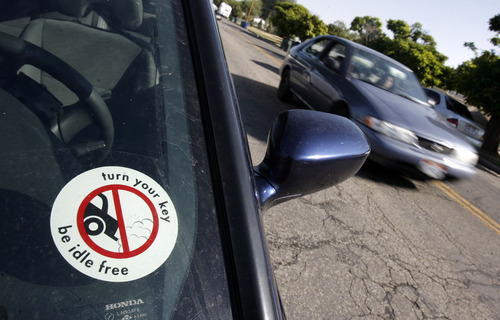 Francisco Kjolseth  |  Tribune file photo
A car sticker promotes being idle free after a press conference launching Idle Free Awareness Month at Mountain View Elementary in 2011. The campaign promotes decreasing excess exhaust contributing to smog by not idling in cars.