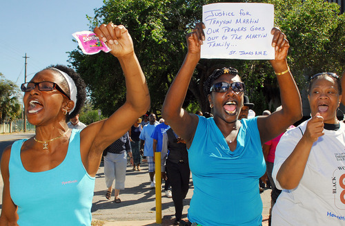 Phoebe Denson, left, Myrtle Hudson march towards the Titusville Courthouse on Sunday, March 18, 2012, in Titusville, Fla. A rally was held demanding justice for Trayvon Martin, a black Florida teenager fatally shot by a white neighborhood watch volunteer. No charges have been filed in the February death. (AP Photo/Florida Today, Craig Rubadoux) NO SALES; MAGS OUT