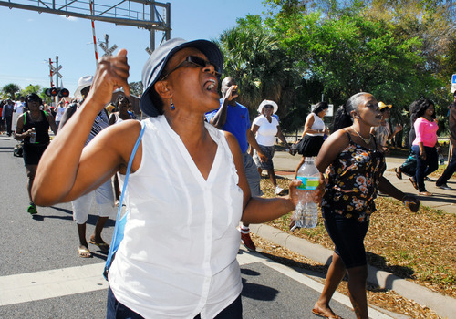 Roni Houston McNeil shouts during a march towards the Titusville Courthouse on Sunday, March 18, 2012, in Titusville, Fla. A rally was held demanding justice for Trayvon Martin, a black Florida teenager fatally shot by a white neighborhood watch volunteer. No charges have been filed in the February death. (AP Photo/Florida Today, Craig Rubadoux) NO SALES; MAGS OUT