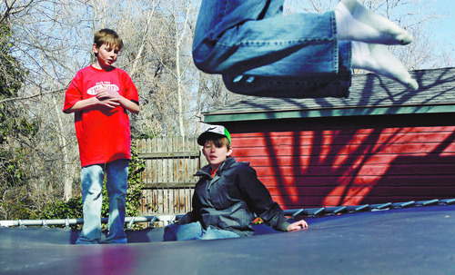Francisco Kjolseth  |  The Salt Lake Tribune
Taylor Green, 10, center, who suffers from bi-polar dissorder, ADHD and anxiety finds plays on the family trampoline with his brother's Josh Cragg, 11, left, and Parker Green, 13, jumping above. Taylor's mom Jamey resently organized a week of events on mental illness at his school of Uinta Elementary.