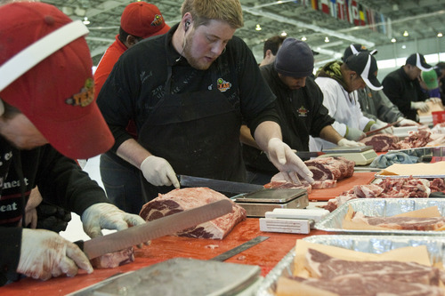 Chris Detrick  |  The Salt Lake Tribune
Tyson John, from Texas Roadhouse in Logan, competes in the semi-final round of the Texas Roadhouse meat-cutting challenge at the Utah Olympic Oval Wednesday March 21, 2012. The meat cutters were judged on the quality, yield and speed of the steaks they cut from forty pounds of beef, consisting of two sirloins, one filet and one ribeye. Eight finalists will advance to the final round, competing for a grand prize of $20,000 and the 