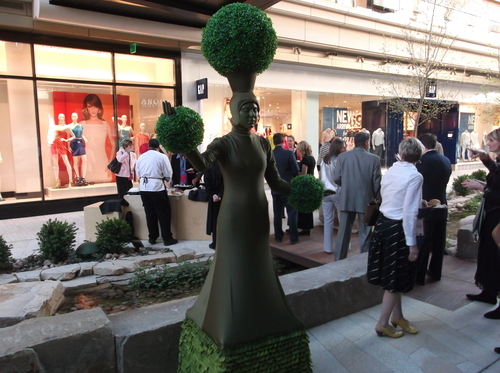 Sean P. Means  |  The Salt Lake Tribune
What am I, a potted plant? A model stands motionless as a planter during Wednesday's charity gala at City Creek Plaza.