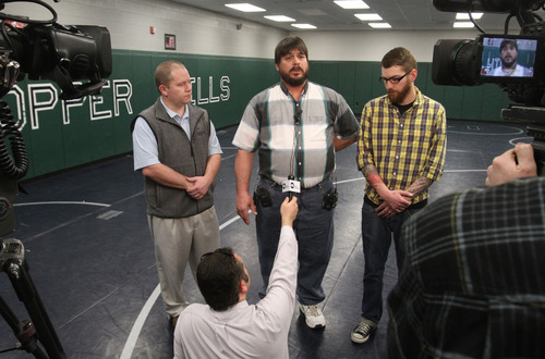 Rick Egan  | The Salt Lake Tribune 

Bret Sackett (center) stands next to John Hatch, a wrestling coach, and his son Grant, (right) as he talks to reporters about the status of his son, at Copper Hills high school, Thursday, February 23, 2012. Sackett accidentally shot his son, Chance,15,  on Saturday at their home in West Jordan.  Chance's classmates at Copper Hills High are raising money to help pay for Chance's medical care at Primary Children's Medical Center.
