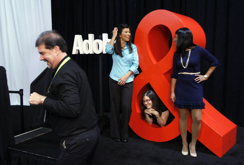 Francisco Kjolseth  |  The Salt Lake Tribune
Photographer Rikk Flohr gets ready on Wednesday to take a picture of Adobe Digital employees Jennifer Sun, left, Ramona Meyer-Piagentini and Kripa Sethumadhavan by the oversized Adobe symbol. Adobe Systems is holding one of the world's largest digital marketing conferences in the world as 4,000 people descend on the Calvin L. Rampton Salt Palace Convention Center in Salt Lake City.