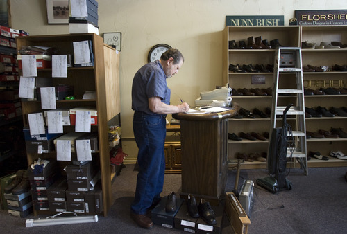 Kim Raff | The Salt Lake Tribune
Gunter Radinger checks inventory Wednesday as he and his wife Carol Gadinger get ready to reopen The Oxford Shop in Salt Lake City.  The shoe store originally closed after the owner Richard Wirick was killed in an accident last month.