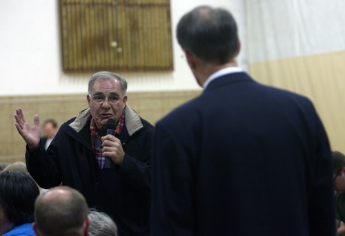 Kim Raff | The Salt Lake Tribune
(left) Duane Call asks stern questions of MTC director Richard Heaton during a neighborhood meeting at Rock Canyon Elementary School in Provo to discuss building a new nine-story MTC building on March 22, 2012.