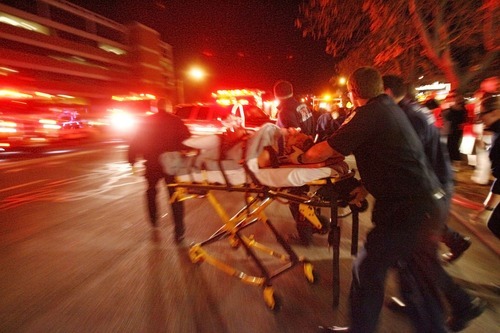 Danny Chan La  |  Tribune file photo
A victim of the shootings at Trolley Square is moved to an ambulance Feb. 12, 2007.