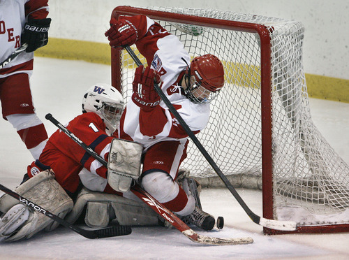 Scott Sommerdorf  |  The Salt Lake Tribune             
Regis Jesuit forward Marshall Conrad gets tangled up with Waterloo goalie Chance Kremer as he battles to push the puck over the goal line for an apparent goal during third period play. Officials later waved off the goal  because Conrad was in the goal crease. The Regis Jesuit (Colo) Raiders won the 2012 USA High School Hockey Championship with a 4-3 win over the Waterloo (Iowa) Warriors, Sunday, March 25, 2012.